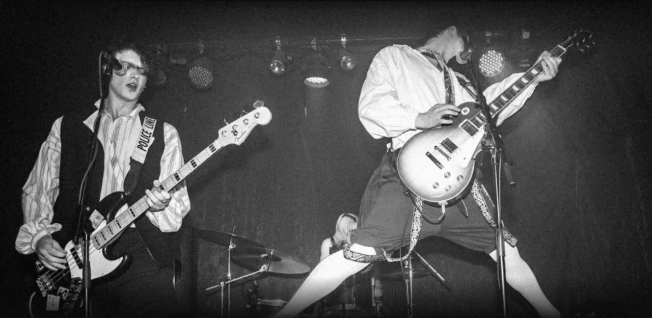 Jasper on bass and Eddie mid-kick, live in black and white
